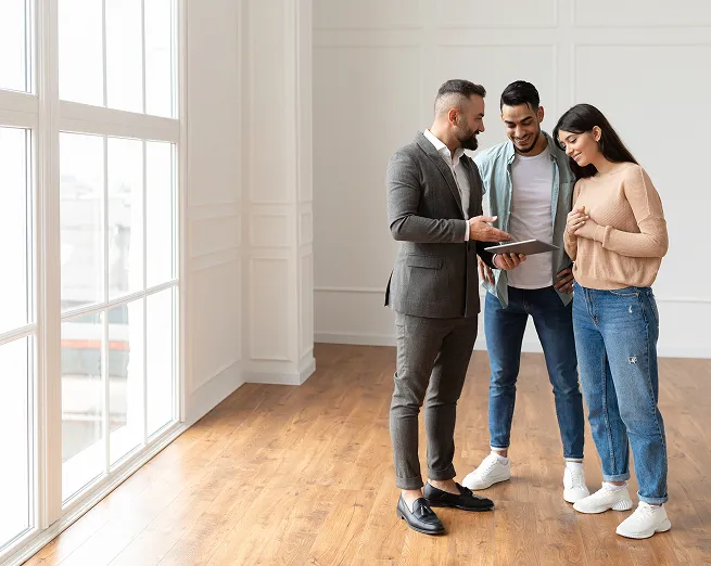 An agent talking to a young couple